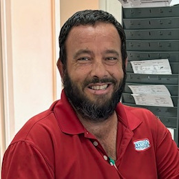 John Blocher, Center Service Manager of AAMCO in South Tampa, Smiling from his desk at the shop